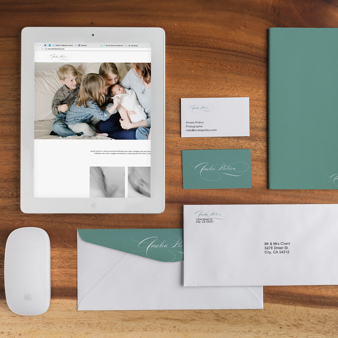 mockup flat flat lay of a stationary set with script logo and seafoam green on wooden table